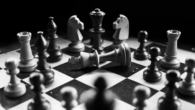 Black-box, grey-box and white-box testing How much to tell your Sumrite pentester, and when. | Sumrite Chess pieces on a board, representing the strategic choice of how much information to give a penetration tester