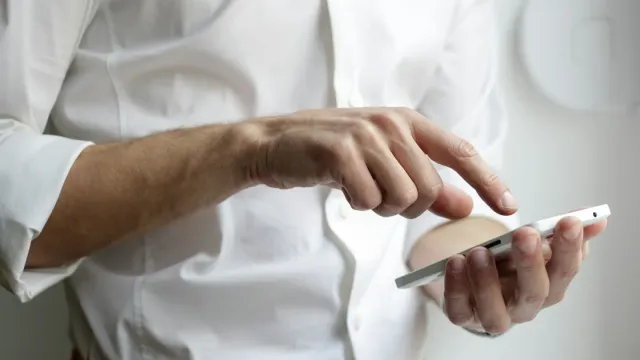 Person holding an Android smartphone with apps on screen, representing mobile app security testing