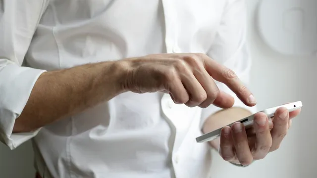 Person holding an Android smartphone with apps on screen, representing mobile app security testing