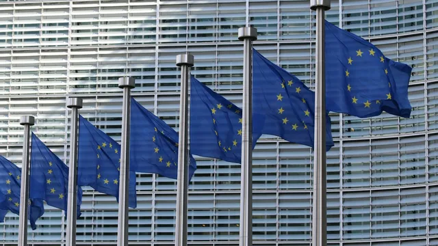 Row of European Union flags outside the European Commission building in Brussels
