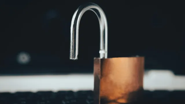 Padlock resting on an open laptop keyboard, representing security safeguards required by India's DPDP Rules